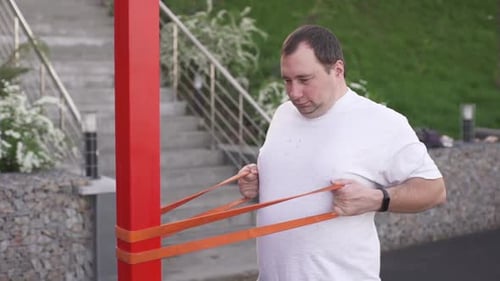 Man Exercising with Resistance Band Outdoors