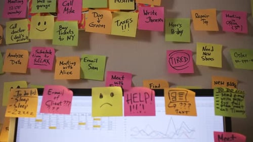 Man Organizing Tasks with Colorful Sticky Notes