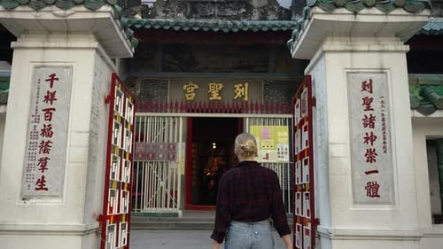 Woman Tourist Enters of a Gate of Traditional Chinese Temple