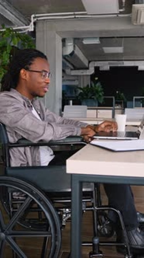 African American Student in Wheelchair Actively Participating in Online Lesson