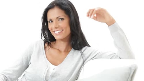 Attractive Woman Smiling on Sofa Relaxing Indoors