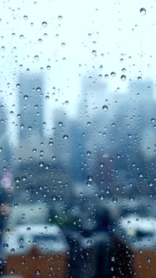 Rainy Cityscape Aesthetic Urban View Captured Through Wet Glass on a Gloomy Day