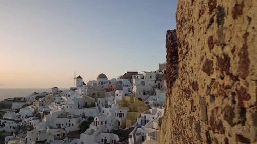 Slow panning shot of Oia in Santorini, Greece during sunset