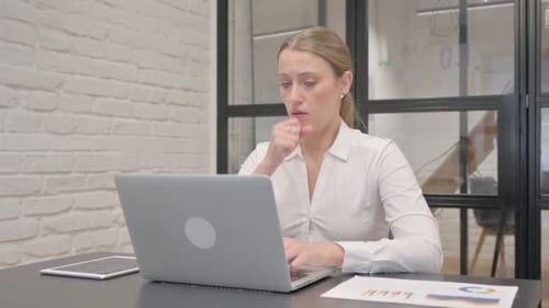 Woman Works on Laptop, Coughing