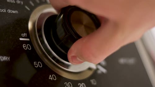 Old-Fashioned Drying Laundry Machine Dial Turning to 60 Minutes, Extreme Close-up