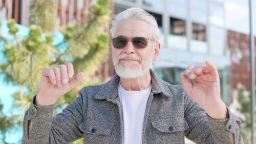 Retired Male Enjoying New Sunglasses While Standing in City