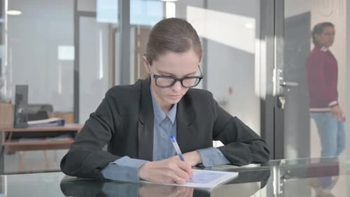 Young Businesswoman Doing Paperwork