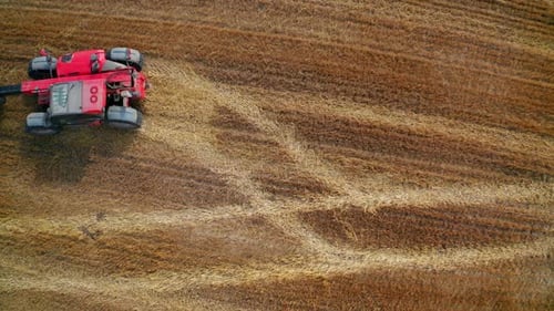 Agricultural machine farming in the field. Top view farming landscapes.