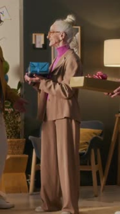 Seniors Celebrating Birthday with Presents in Home Interior