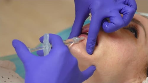 Woman Receives Lip Filler Injection Procedure