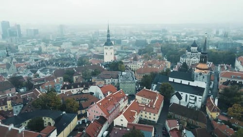 Aerial birds eye shot over old town of Tallinn City during cloudy day in Estonia