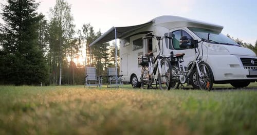 Idyllic RV Camping in Forest Meadow at Sunrise