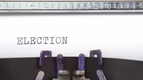 Election word close up being typing and centered on a sheet of paper on old vintage typewriter