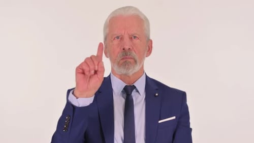Senior Man in Suit Shakes Finger Indicating No