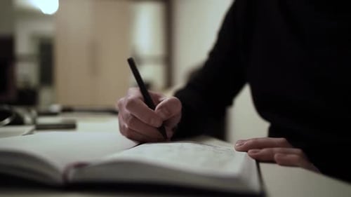 Hand Writing in a Notebook Close-up