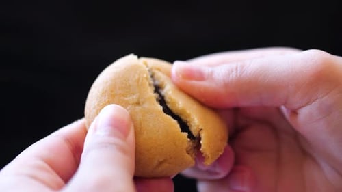 Breaking Open Chocolate Filled Cookie for Dessert