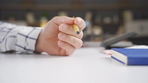 Close-up hand turning the pen, Thought.