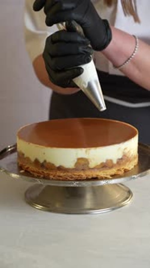 A chief adds vanilla to a caramel cake, close up shot, insert shot