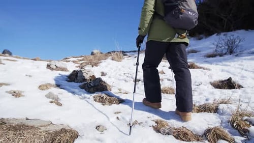 Unrecognizable senior man trekking up snow covered hills in slovakia winter