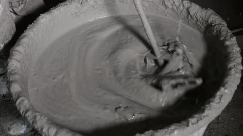 Cement Being Mixed in Bucket Close Up