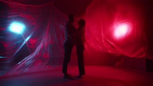 A Young Couple is Kissing in the Studio Two Lovers Kisses Indoors Beautiful Family Hugs and Flirting