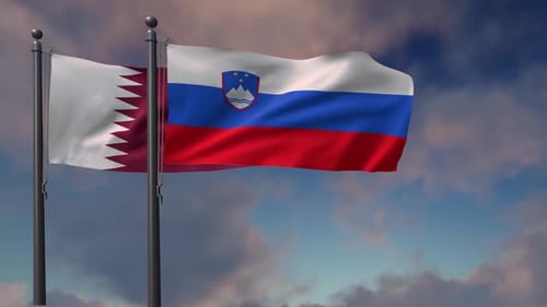 Qatar and Slovenia Flags Waving on Flagpoles Against Cloudy Sky