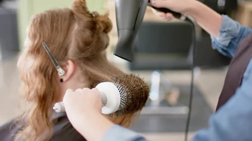 Hair Stylist Blow Drying Client's Hair