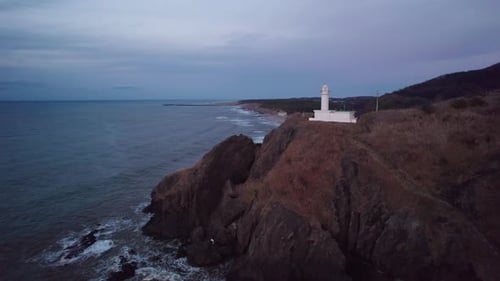 Lighthouse Overlooking Ocean Waves