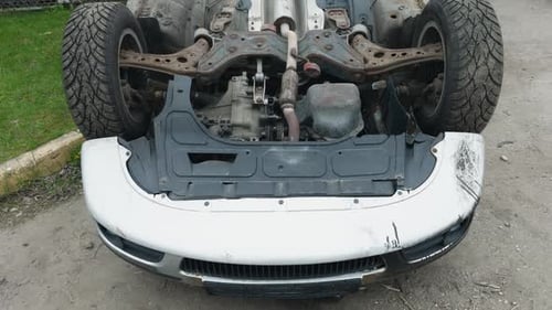 A Vehicle with Open Hood is Parked By the Roadside