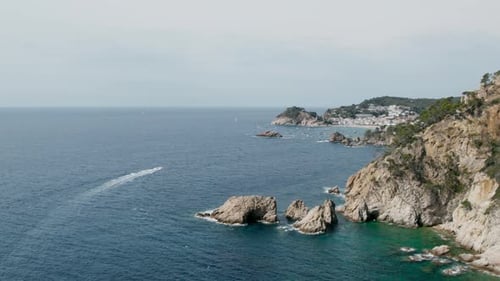 Drone Shot of Motorboat Sail Into Bay or Cove