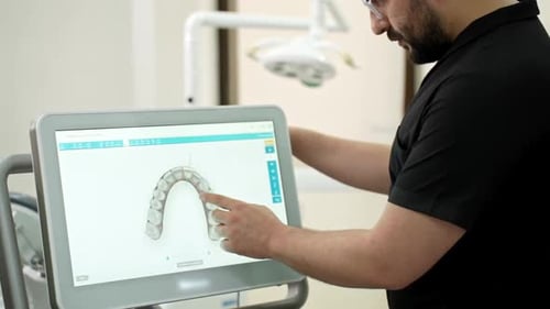 Dentist Showing Human Jaws Models on Digital Screen Conducting Presentation of Innovative Treatment