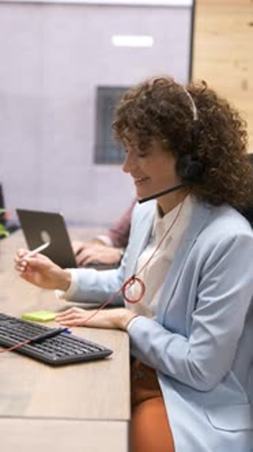 Woman with Headset Working in an Office