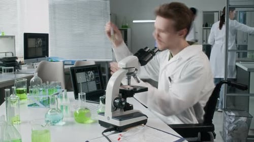 Scientists Working with Microscope and Samples in Lab