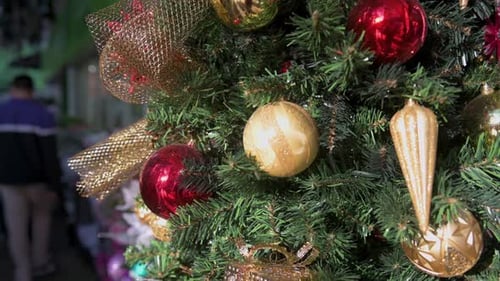 Christmas Tree Decorated With Gold and Red Ornaments