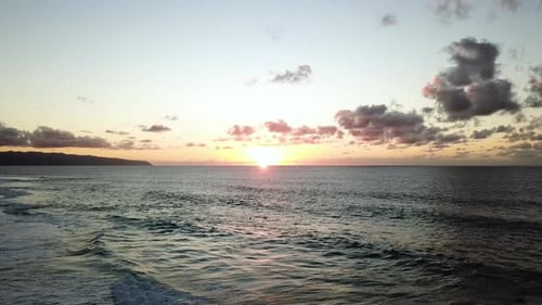 Surfers during Sunset on North Shore Coast of Oahu, Hawaii, Aerial Drone