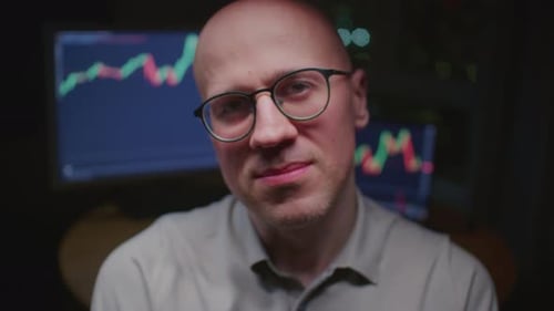 Man Stock Trader in Home Office Male Analyzes Terminal Trades Stocks on Crypto Market Candlestick