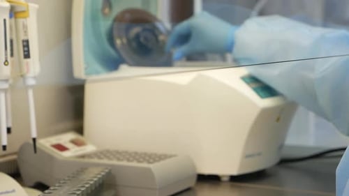 Scientist Handling Vials in a Laboratory