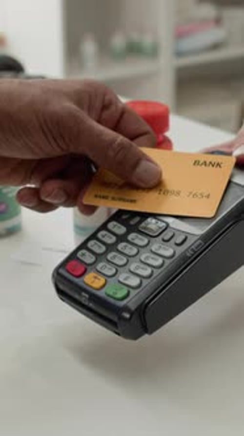 Male Customer Buying Medication using Credit Card in Drugstore Vertical