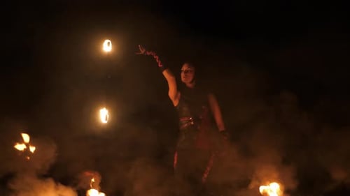 Woman Fire Dancing Performance at Night