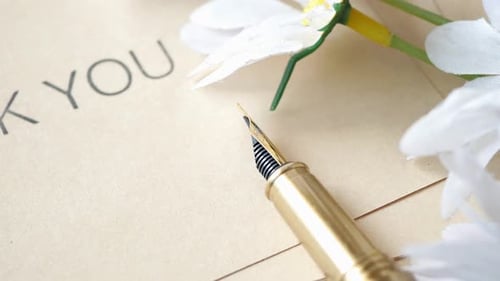 Thank You Note with Golden Pen and Flowers