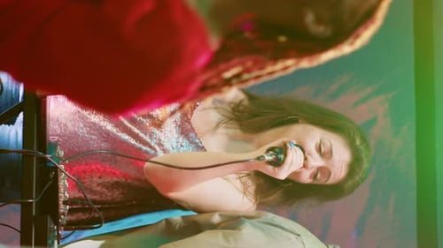 Female Performer Sings on Stage at Night