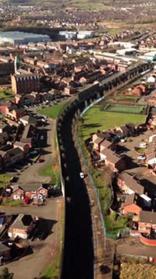 Descending social ratio aerial video of the Belfast Peace Walls on a bright sunny day