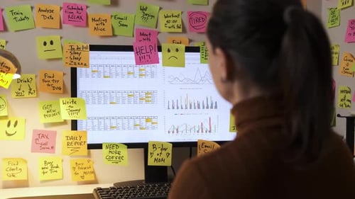 Adult working at a Computer with Sticky Notes
