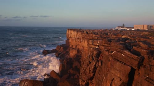 Waves Crashing on Rocky Cliffs at Sunset