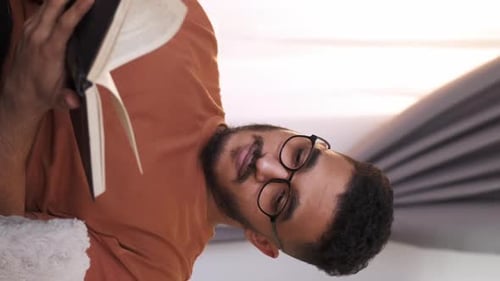 Man Reading Book Indoors