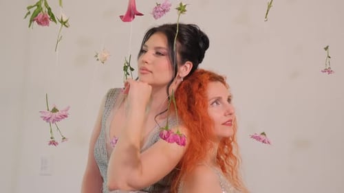 Elegant Women Posing with Decorative Flowers