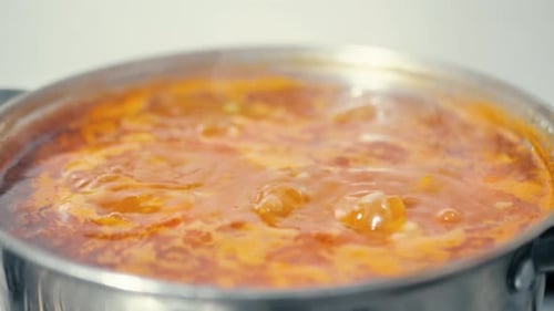 Hot Stew Simmering in Pot with Spoon
