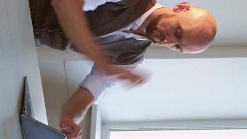 Adult Man Working on a Laptop Indoors