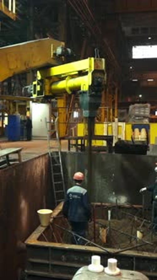 Foundry Workers Pouring Molten Metal Into Mold Stock Clip