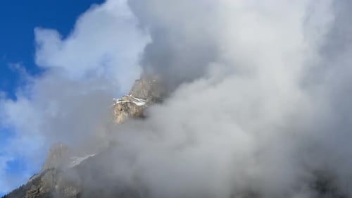 Mountain Peak Shrouded in Clouds, Blue Sky